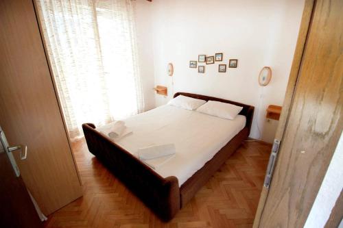 a bedroom with a large bed in a room at Apartments by the sea Mandre, Pag - 6373 in Kolan