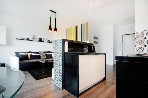 a living room with a couch and a table at JTB Nautica Aparthotel in Szczecin