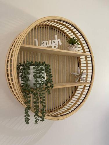 a wicker shelf with potted plants on it at Santana's Getaway in Agnes Water