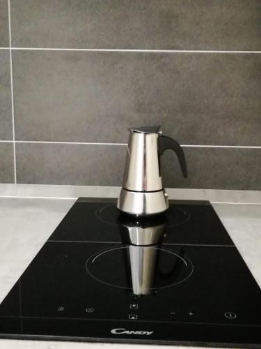 a coffee pot sitting on top of a black napkin at NEL CUORE DI PADOVA PER 2 - 028060-LOC-01359 in Padova