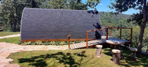 a wooden bench in front of a building at Green Paradise Glamping in Covas
