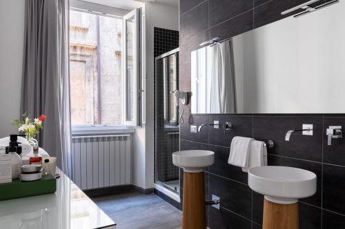 een badkamer met een wastafel, een toilet en een raam bij Now Apartments, ApartHotel in the heart of Rome in Rome