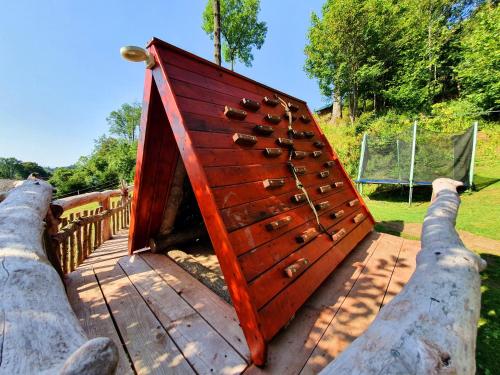 a wooden door with a bunch of shoes in it at Penzion U Sovy in Dolný Kubín