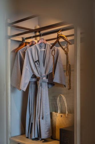 a closet with a blue robe and a basket at Thai Fight Hotel in Lamai