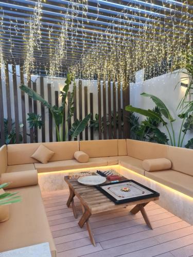 a living room with a couch and a table at Villa Bali Jeddah in Jeddah