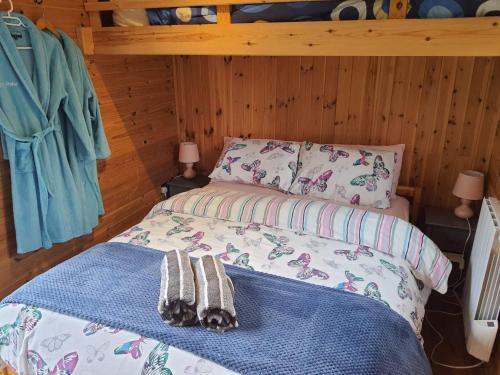 a bedroom with a bed with two towels on it at Stunning railway carriage with private hot tub in Hereford