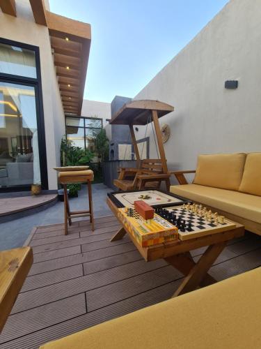 a living room with a chess board on a table at Villa Bali Jeddah in Jeddah