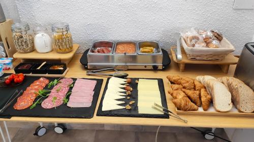 a table with many different types of food on it at Hostal Residencia Alma in Port d'Alcudia