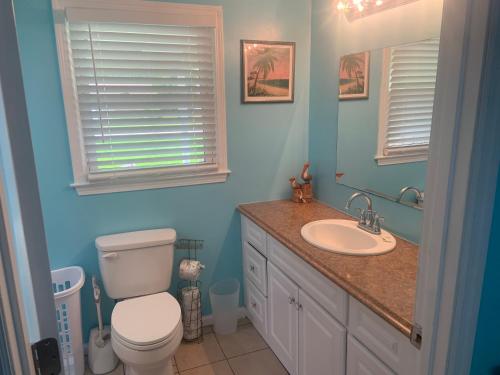 a bathroom with a toilet and a sink at Cheerful two bedroom house 1.5 miles from beach. in Myrtle Beach
