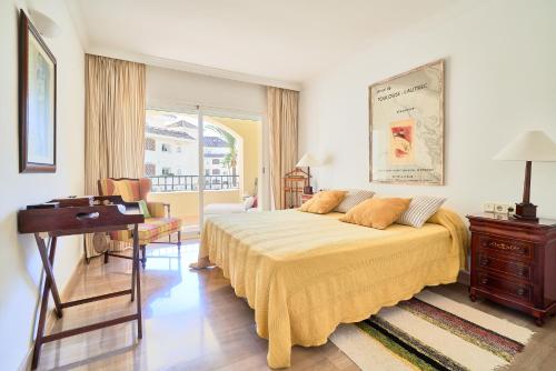 ein Schlafzimmer mit einem Bett, einem Schreibtisch und einem Klavier in der Unterkunft Marbella SunCity in Marbella
