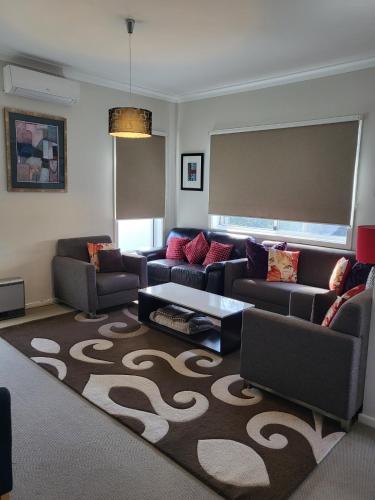 a living room with a couch and a table at Blue on Cooper in Katoomba