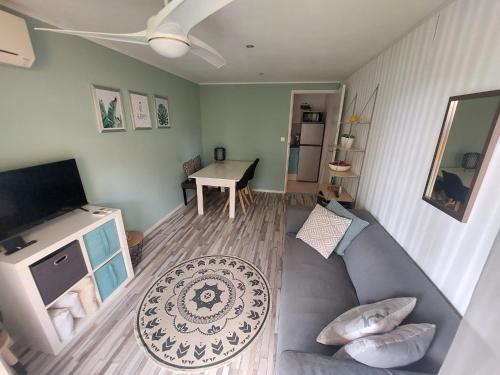 a living room with a couch and a television at B&B Casa Trankilo in Kralendijk