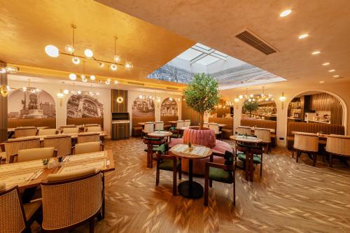 a restaurant with tables and chairs in a room at Mukarnas Pera Hotel in Istanbul