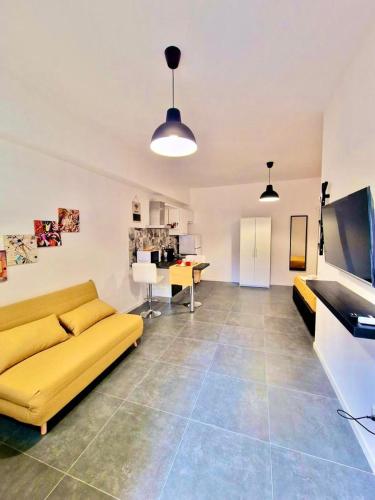 a living room with a yellow couch and a table at FriendlyHouse in Bologna