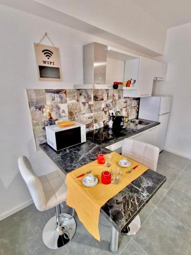 a kitchen with a table with chairs and a counter top at FriendlyHouse in Bologna