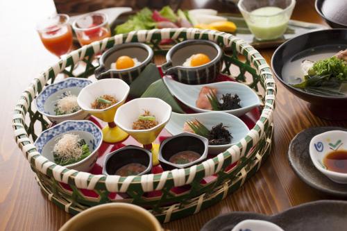 a basket filled with dishes of food on a table at Iwaiyado Jyuan Nikko Kawaji onsen in Nikko