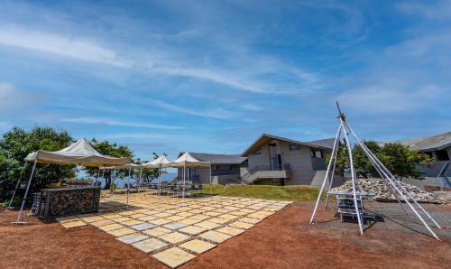 a patio with a table and a tent in front of a house at Vee Resort- The Suites of Royals in Mahabaleshwar