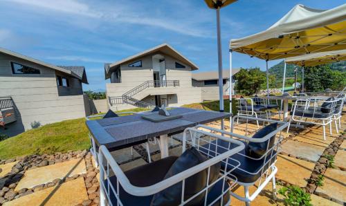 a picnic table and chairs on a playground at Vee Resort- The Suites of Royals in Mahabaleshwar