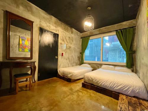 a bedroom with two beds and a desk and a window at TwoTwo House in Seoul