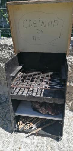 a grill with a sign on top of it at Casinha da Mó in Vieira do Minho