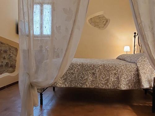a bedroom with a bed and a window at Nel vicolo dei Baci - Casa vacanze al Bacio in Spello