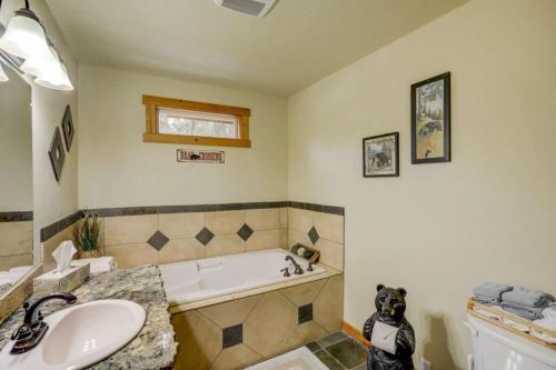 a bathroom with a dog sitting next to a bath tub at 1 Particular Pine by Casago McCall - Donerightmanagement in McCall