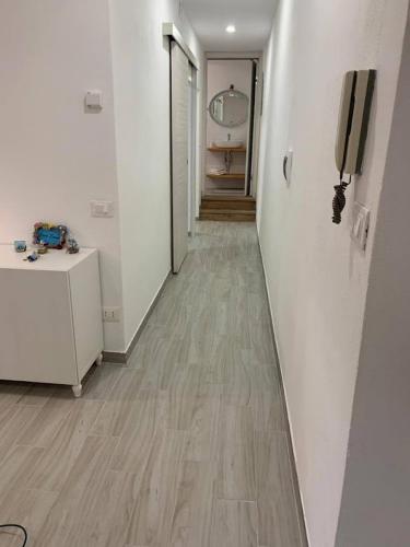 a hallway with white walls and a phone on a wall at Casa Emma in Chiavari