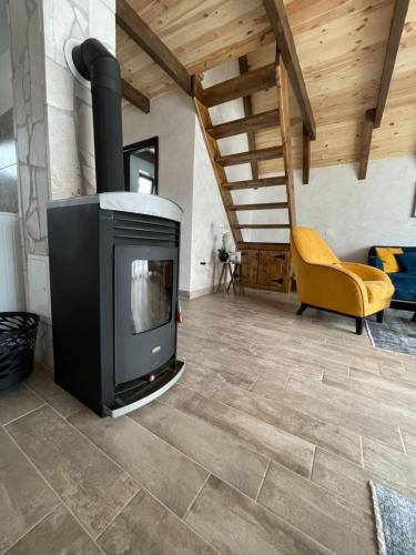 a living room with a wood stove in a room at Lux Villas Zabljak in Žabljak