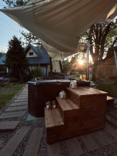 a hot tub with a wooden bench under a tent at Chata Na Krańcu Świata in Łączna