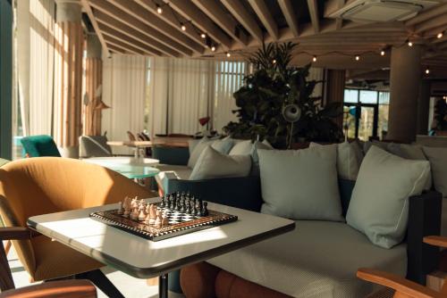 a room with a couch and a chess board on a table at ibis Budget La Rochelle Centre gare in La Rochelle