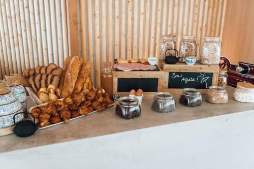 a table topped with lots of different types of bread at ibis Budget La Rochelle Centre gare in La Rochelle