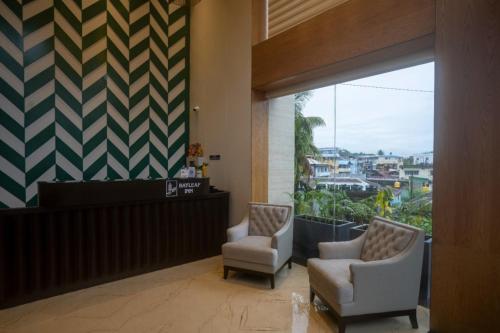 a lobby with two chairs and a waiting room at BayLeaf Inn in Port Blair