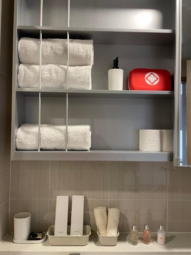 a towel rack with towels and towels in a bathroom at Luxury Condo in Clark Pampanga beside Hilton Hotel and Casino in Angeles