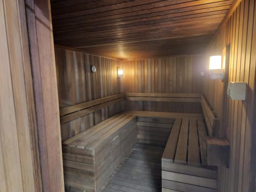 a wooden sauna with a bench in it at 40 William Street Apartments in Port Macquarie