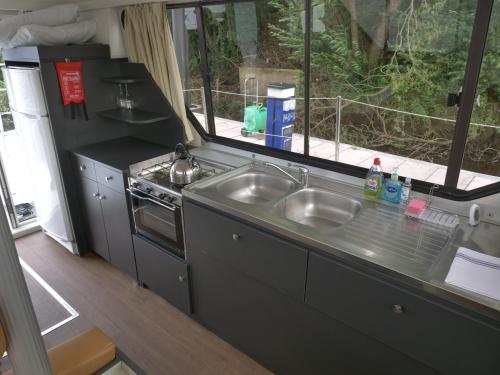 a small kitchen with two sinks and a window at Vivienne in Ballymoney