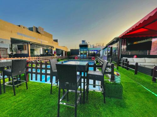a patio with a table and chairs next to a pool at Smana Hotel Al Raffa in Dubai
