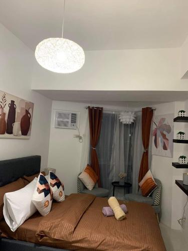 a bedroom with a large bed with pillows on it at Grand Riviera Suites Comfy Condo near US Embassy Manila Bay Roxas Blvd Ermita Manila in Manila