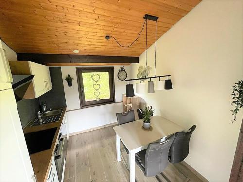 a kitchen with a table and chairs in a room at Sauerländer Henne-Lütt in Meschede