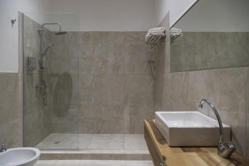 a bathroom with a shower and a sink at Haus Apart Hotel in Salta