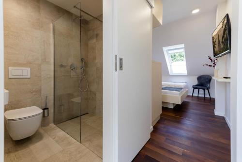 a bathroom with a shower and a toilet and a sink at Pension Chmelnice in Napajedla