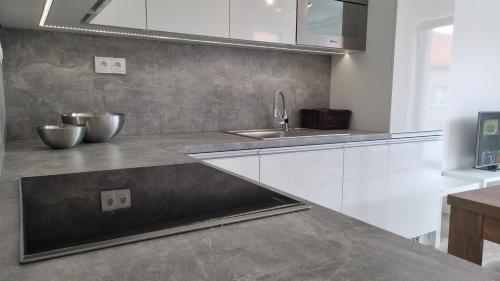 a kitchen with white cabinets and a sink at Lovely 1 bedroom apt in middle of city centre in Blansko