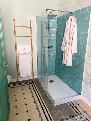 a bathroom with a shower with blue tile at Patios del Agua in El Puerto de Santa María