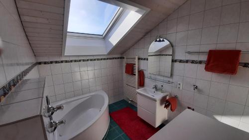 a bathroom with a sink and a toilet and a window at Ferienwohnung Kunze in Prien am Chiemsee