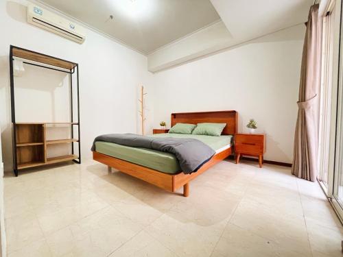 a bedroom with a bed in a room at Super Cozy 2BR Apt with direct access to Mall in Jakarta