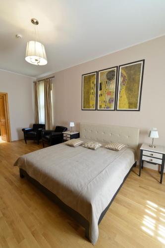 a bedroom with a large bed and a living room at Pensiunea Elphin in Târgu-Mureş