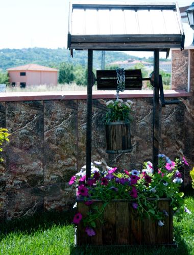 a bunch of flowers in a pot on a wall at DEFNE OTEL in Sile
