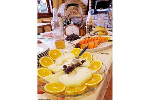 a table topped with a plate of cheese and oranges at Mansão Austríaca Guesthouse in Campos do Jordão