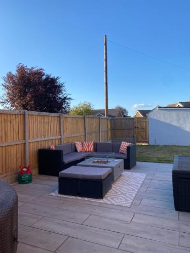 a patio with a couch and a coffee table at Luxury Recently Renovated 3 Bedroom home in Sandwich Kent in Sandwich