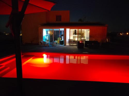 a house with a red pool at night at Suite12 in Marsala