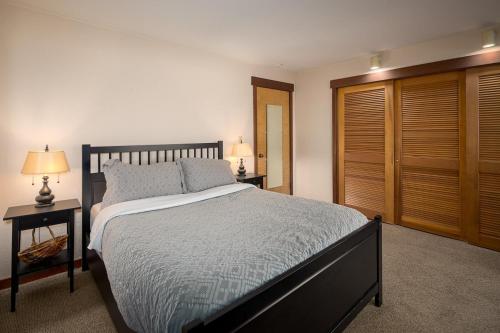 a bedroom with a large bed and a wooden closet at Granite River Retreat at Alpine Meadows in Alpine Meadows